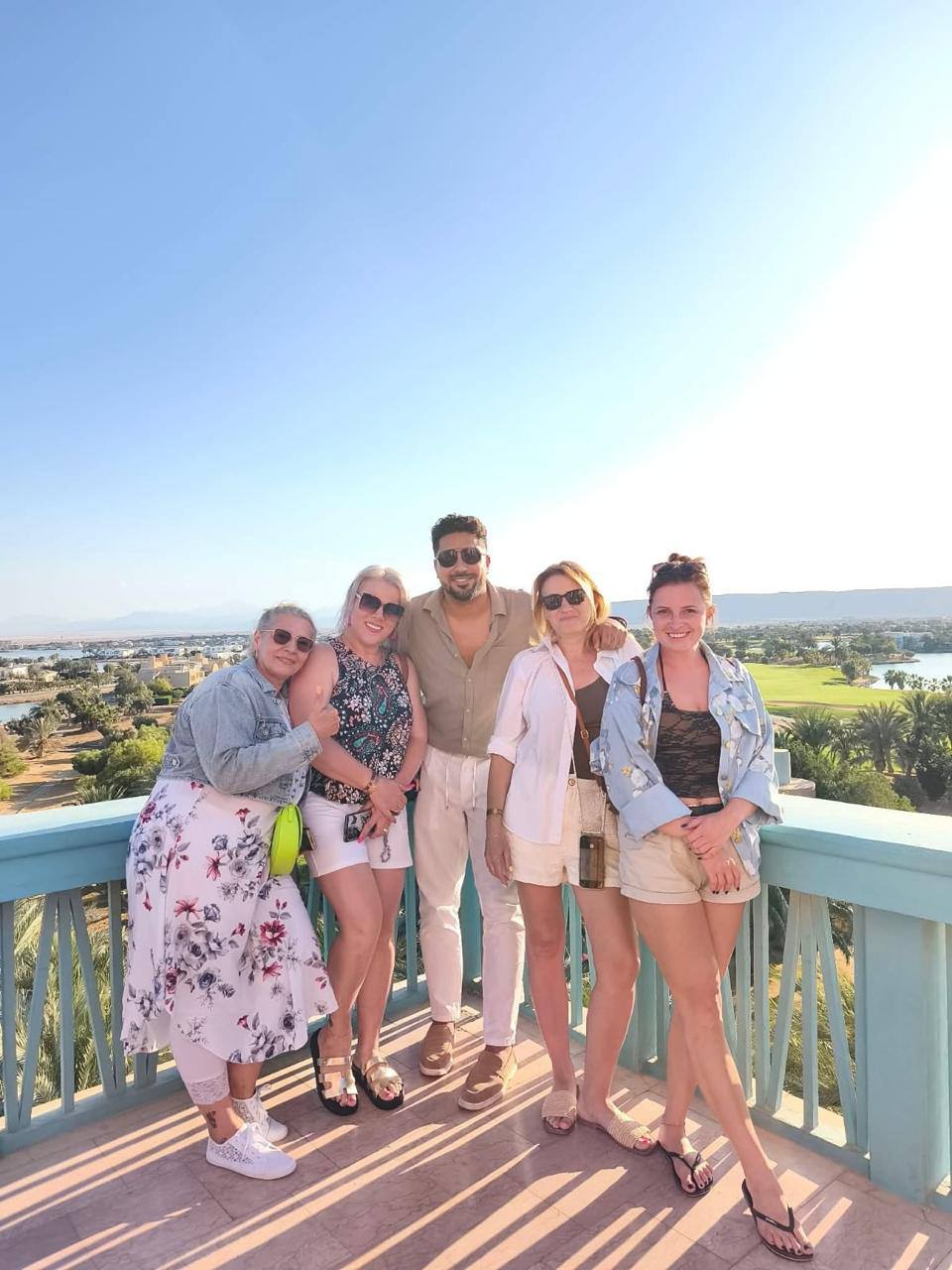 A group at a viewpoint over the lagoons and greens of El Gouna
